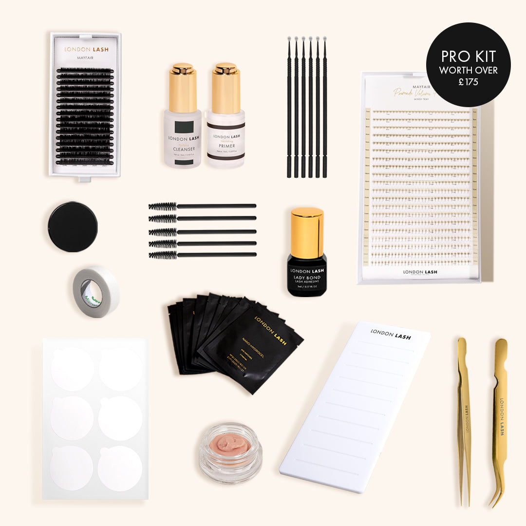 contents of London lash classic extension kit such as lash trays, tweezers, bottles of glue, glue stone, eyelash pallet, mannequin head.