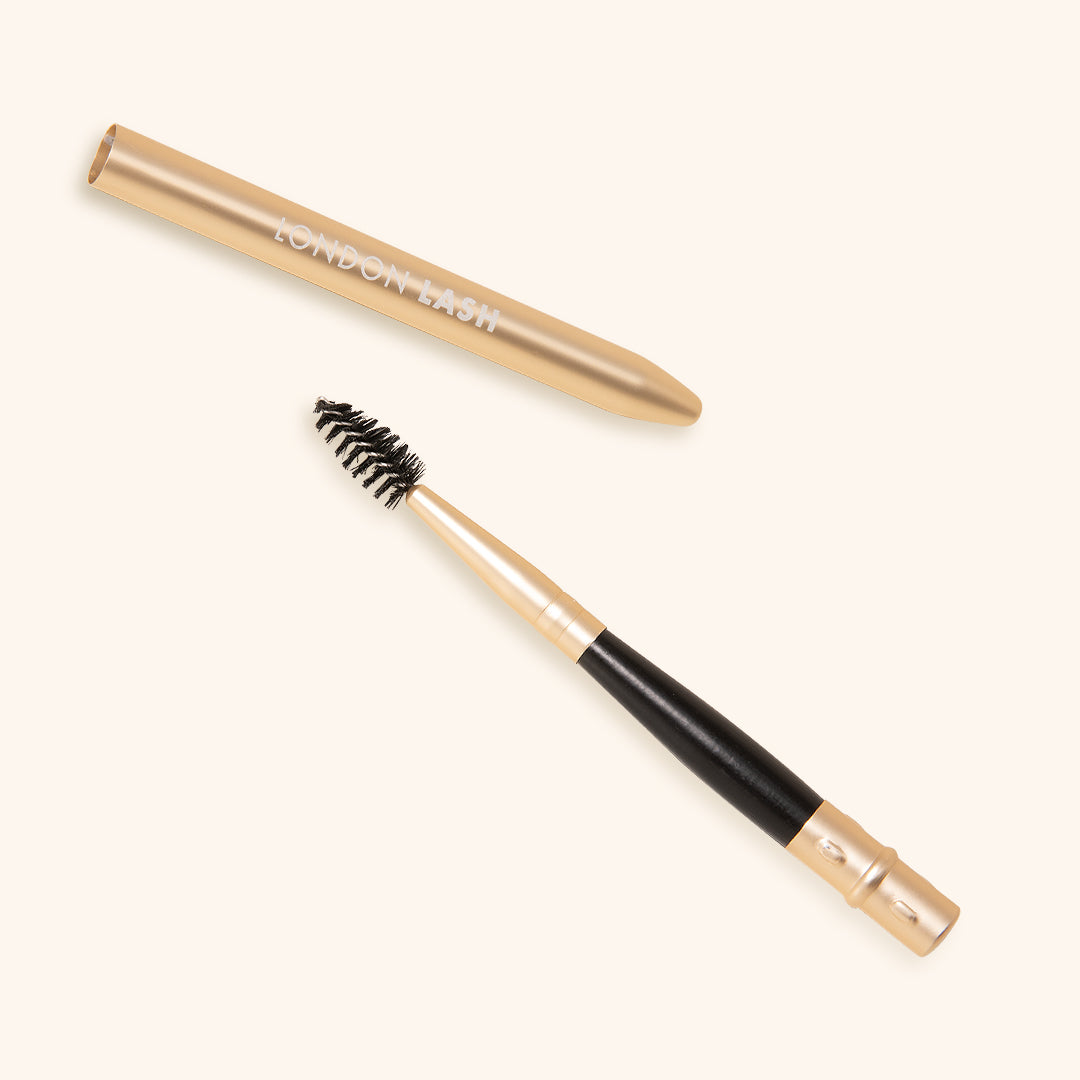 eyelash brush with protective metallic cap in gold colour