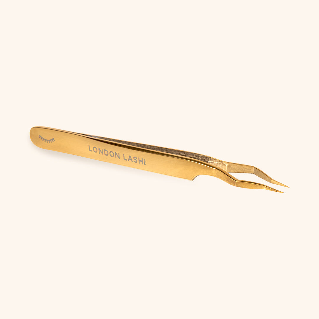 picture of gold isolation tweezers in full size with london lash engraving 