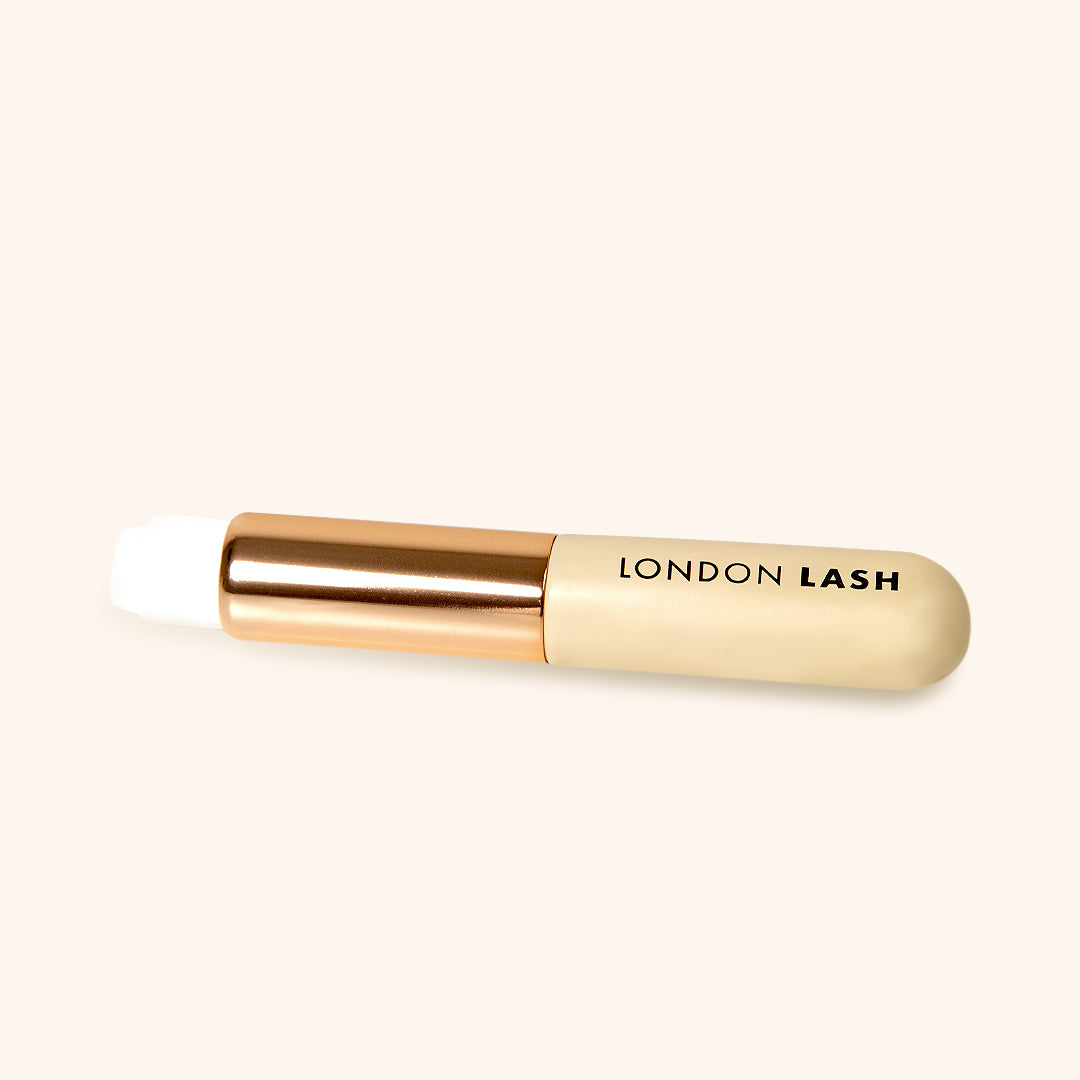 lash cleansing brush with white soft synthetic fiber and metallic gold and wooden beige handle