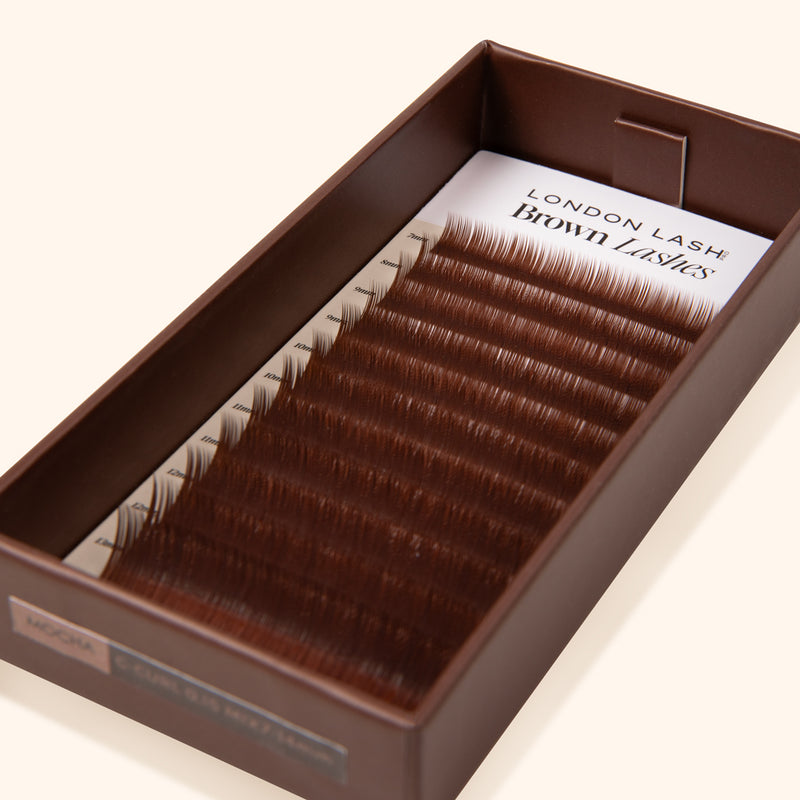 lash tray on beige background with coffee shade brown eyelashes inside
