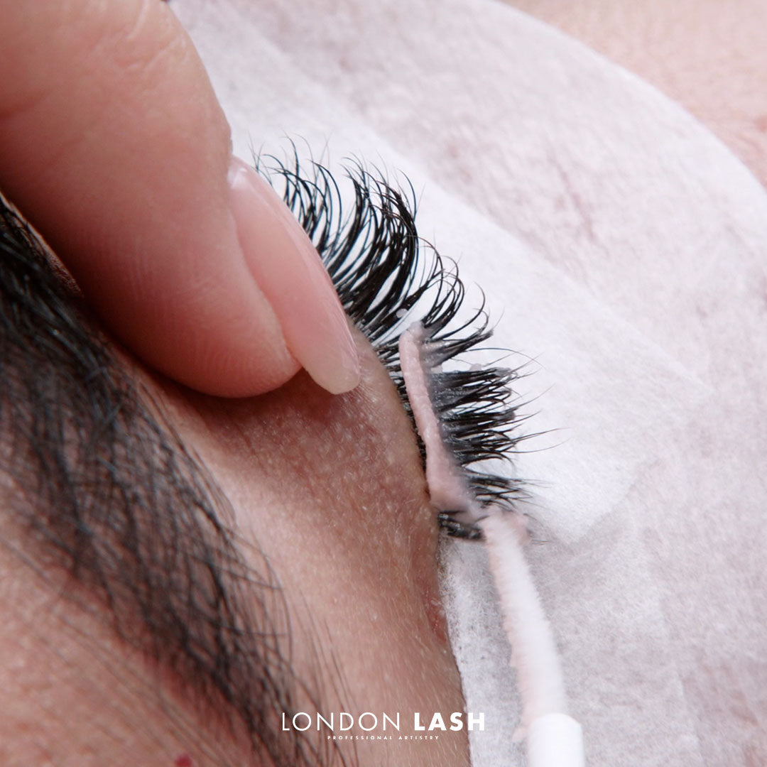 closeup of lash remover application with micro brush