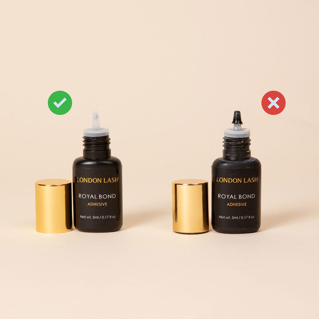 two glues stand side by side, one has a clean nozzle and the other has a buildup of lash glue